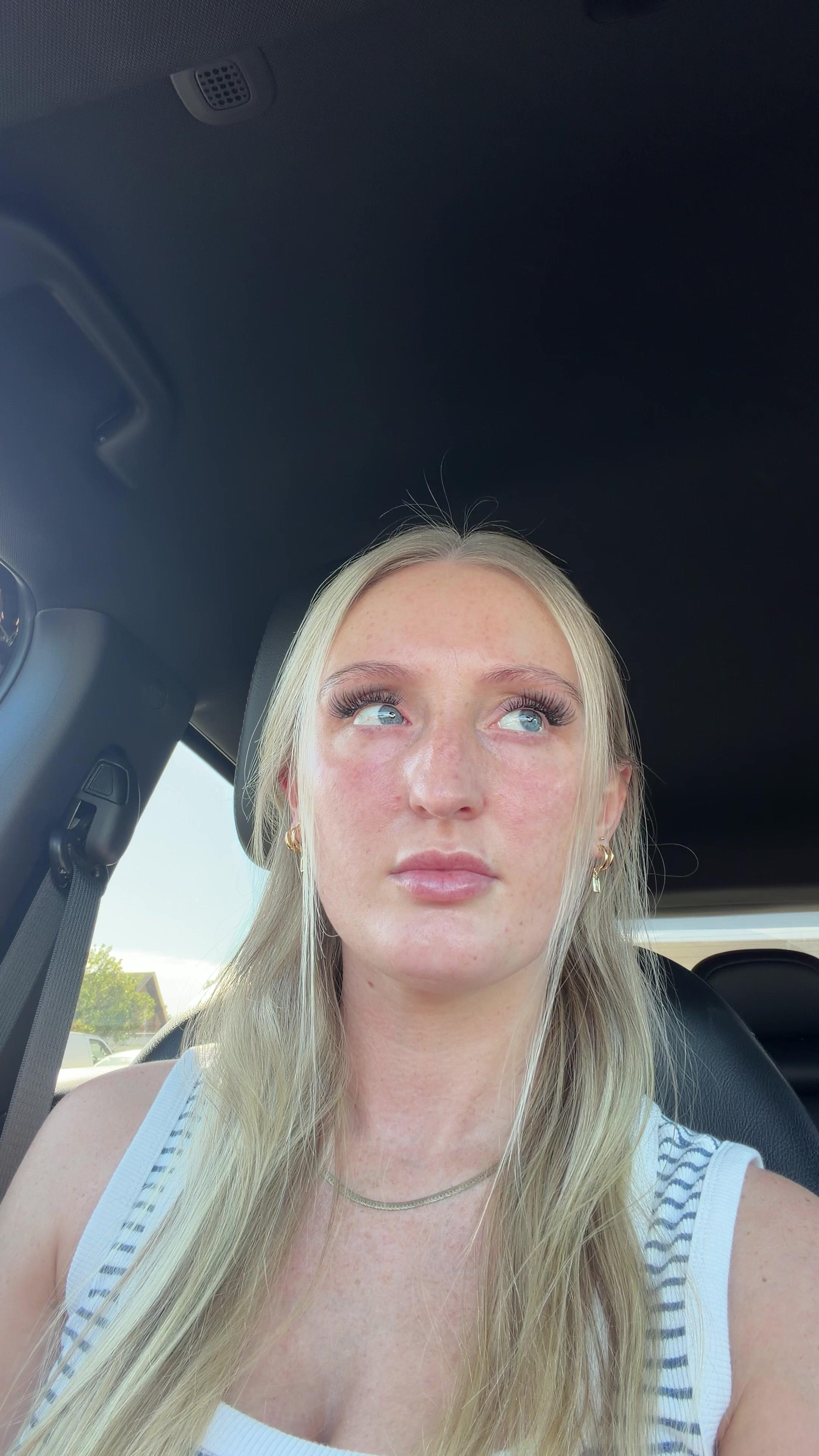 Tired Blonde Woman Yawning in Car