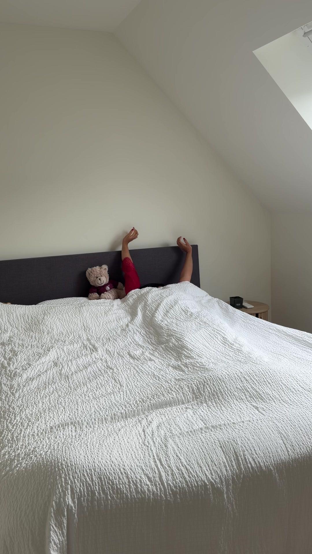 Person Stretching and Waking Up in Bed